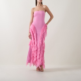 Model wearing Elliatt pink strapless gown with cascading ruffle mesh skirt overlay, styled with strappy heeled sandals