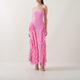Model wearing Elliatt pink strapless gown with tiered ruffle skirt, styled with clear heeled sandals