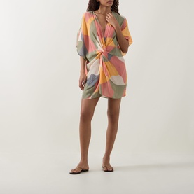 Model wearing Eres Nuance Printed Kaftan in multi colourway, featuring V-neckline, twist detail and short sleeves, styled with flat sandals.