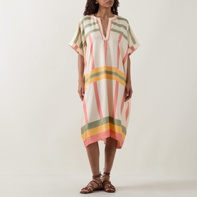 Model wearing Eres multicolour striped silk kaftan dress with V-neckline and short sleeves, styled with brown leather sandals