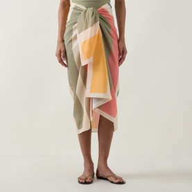 Model wearing Eres Croquant Printed Sarong in multi colourway, block stripe pattern with self-tie fastening, styled with flat sandals