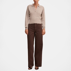 Model wearing Forever New Chocolate wide-leg trousers with a beige knit polo top.
