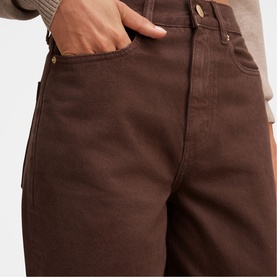Model wearing Forever New chocolate wide-leg jeans, high-waisted with classic five-pocket styling, paired with a grey knit top.