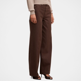 Model wearing Forever New chocolate wide-leg trousers with belt loops, styled with a cream knit top and black heels.
