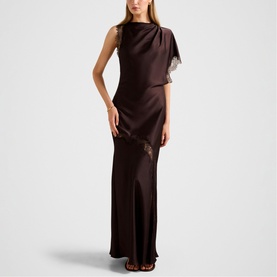 Model wearing Forever New Dark Chocolate maxi dress with draped one-shoulder overlay and lace trim detailing, front split skirt