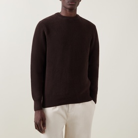 Model wearing Les Deux Mole Brown cotton crew neck jumper, styled with off-white trousers