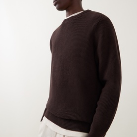 Model wearing Les Deux Mole Brown cotton crew neck knit sweater with ribbed texture, styled with white crew neck underneath.