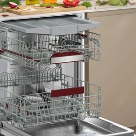 Neff N70 Built-In Dishwasher 60cm open, showing three adjustable wire racks loaded with dishes, cutlery basket, and red rack clips