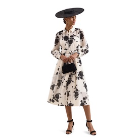 Model wearing Phase Eight white floral print midi dress with black rose pattern, styled with black wide-brim hat, clutch bag and heeled sandals