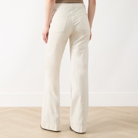 Model wearing Seven Jeans Modern Dojo High-Rise Wide Leg Jeans in ecru, rear view showing wide-cut legs, five-pocket style and belt loops.