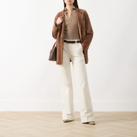Model wearing Seven Jeans Modern Dojo High-Rise Wide Leg Jeans in ecru, styled with a brown suede blazer, tan top, and brown bag.