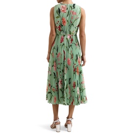 Model wearing green floral sleeveless midi dress with pleated skirt, shown from the back, styled with white heeled sandals