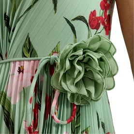 Model wearing sage green pleated floral midi dress with red flower print and corsage belt detail at waist