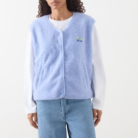 Model wearing American Vintage Hoktown Logo Gilet in Givre Chine, light blue fleece, snap buttons, styled with white long-sleeve top and jeans