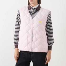 Model wearing American Vintage pink quilted gilet with gold logo patch, styled over a striped long-sleeve polo shirt.