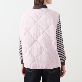 Model wearing American Vintage pink quilted gilet, back view, styled with striped long-sleeve top and dark jeans