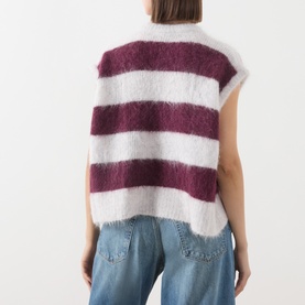 Model wearing American Vintage knitwear in rayures cranberry, bold burgundy and white stripes, fluffy alpaca sleeveless vest, styled with blue jeans,