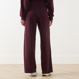 Model wearing American Vintage Atubay Drawstring Wide Leg Sweatpants in Lie de Vin, wide-leg silhouette with elasticated waist, styled with matching