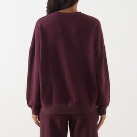 Model wearing American Vintage Atubay Logo Sweatshirt in Lie de Vin, crew neck, long sleeves, ribbed trims, styled with matching trousers