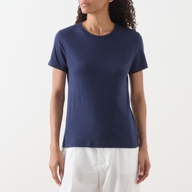 Model wearing American Vintage Apoly Solid T-Shirt in Night Star, crew neck, short sleeves, styled with white trousers