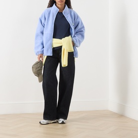 Model wearing American Vintage Sonoma Long-Sleeved Slub T-Shirt in Navy Blue Vintage, styled with light blue fleece jacket, black wide-leg trousers