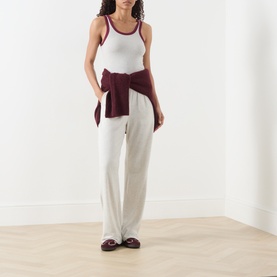 Model wearing American Vintage Cribay Contrast-Trim Tank Top in Gris Chine with burgundy trim, styled with cream wide-leg trousers and burgundy