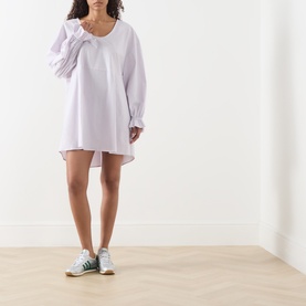 Model wearing AMERICAN VINTAGE Soabird Striped Tunic in Rayures Douceur, scoop neck, flared cuffed sleeves, styled with green trainers