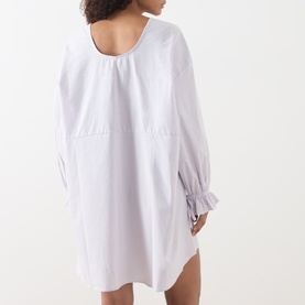 Model wearing American Vintage Soabird Striped Tunic in Rayures Douceur, showing back view with elasticated flared cuffs and curved hem.