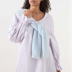 Model wearing American Vintage Soabird Striped Tunic in Rayures Douceur, scoop neck, long sleeves with tie cuffs, light blue knit tied at neck