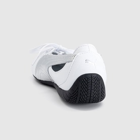 Puma white and silver leather trainer, rear view showing black ridged rubber sole and silver heel branding.