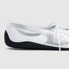 Puma white and silver leather lace-up trainer with quilted silver panel detail and black rubber sole, close-up toe view