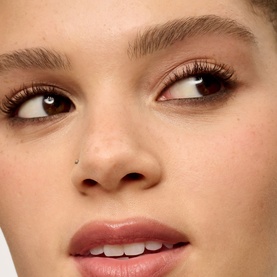Model with Benefit Eye Liner in Midnight Brown, shown as a close-up eye look with defined lashes and a subtle glowy complexion