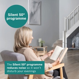 Lifestyle shot showing woman reading in armchair beside a tumble dryer, with text highlighting the Silent 50&deg; programme for quiet evening use.