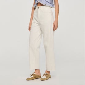 Model wearing Sandro clear wide-leg cropped trousers, styled with a blue striped top and beige boat shoes
