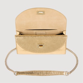Sandro yellow metallic gold crossbody bag, open view showing beige interior, gold-tone chain strap and clasp fastening.