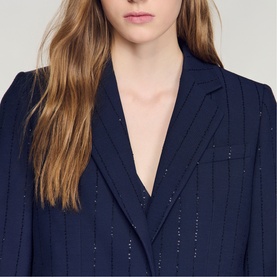 Model wearing Sandro Womens French Dress in dark navy with pinstripe sequin detail, V-neckline and notched lapel collar.