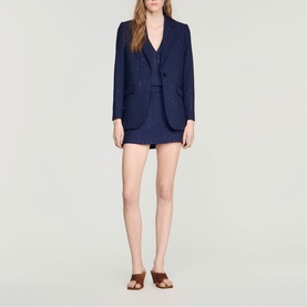 Model wearing Sandro Womens French Dress in dark navy, styled with matching blazer and shorts, brown flat sandals.