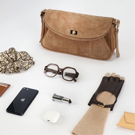Sandro Le Mambo Suede Shoulder Bag in tan with swivel clasp, styled with glasses, gloves, phone and scrunchie