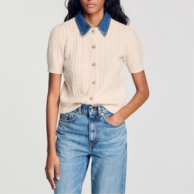 Model wearing Sandro cream cable-knit short-sleeve cardigan with denim collar, styled with blue jeans