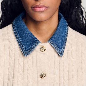 Model wearing Sandro cream cable-knit cardigan with denim collar and gold floral buttons