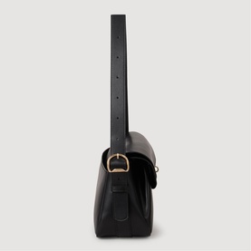Sandro Le Mambo Leather Shoulder Bag in black, side profile showing adjustable shoulder strap with gold-tone branded buckle detail.