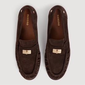 Sandro brown suede loafers with gold-tone buckle detail, viewed from above on grey background.
