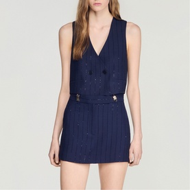 Model wearing Sandro Womens French Dress in dark navy, sleeveless V-neck with double-breasted buttons and pinstripe mini length.