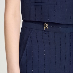 Model wearing Sandro Womens French Dress in dark navy, featuring sparkle stripe texture and gold logo belt buckle detail.