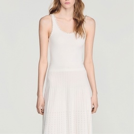 Model wearing Sandro Womens French Dress in clear white, featuring ribbed tank bodice and pleated midi skirt.