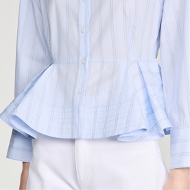 Model wearing Sandro sky blue striped cotton shirt with ruffle peplum hem and flared cuffs, styled with white trousers