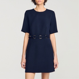 Model wearing Sandro Womens French Dress in navy blue, short sleeves, crew neck, with silver ring-detail belt waistband.
