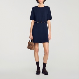 Model wearing Sandro Womens French Dress in navy blue with double-buckle waist detail, styled with brown mini bag and black loafers.