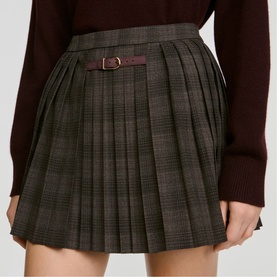 Model wearing Sandro dark grey plaid pleated mini skirt with belt detail, styled with a dark brown knit jumper