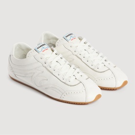 Sandro white leather low-top trainers with tonal flame stitching detail and tan gum sole, pair shown at angle